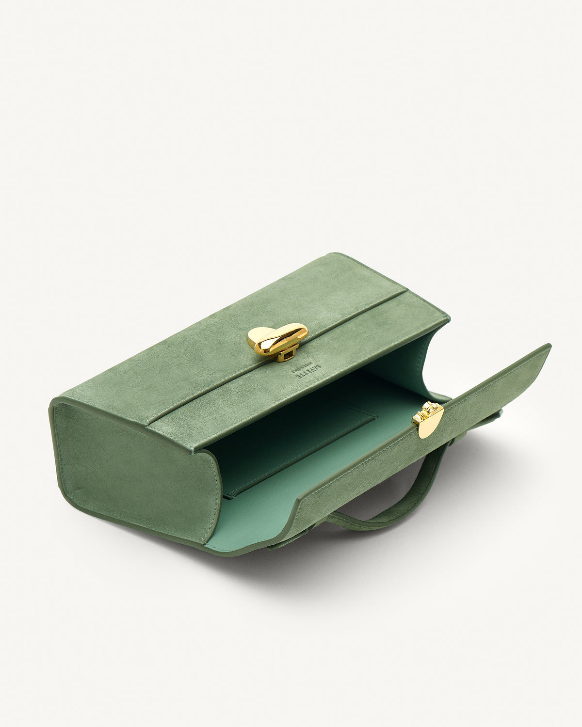 Inside view of cactus suede top handle handbag with gold hardware
