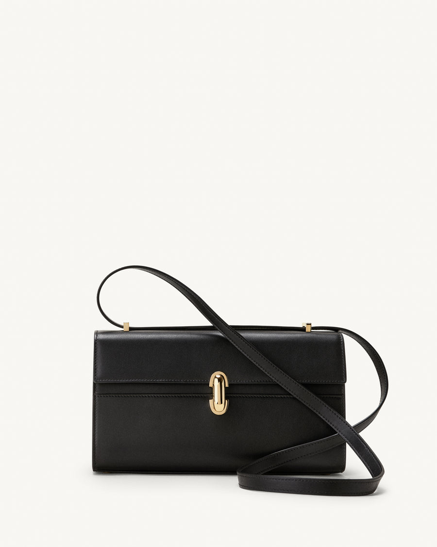 front view of a black leather bag with a gold clasp on a white background