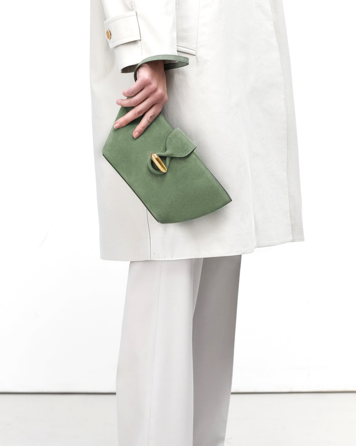 On model view of cactus suede pouch with gold hardware