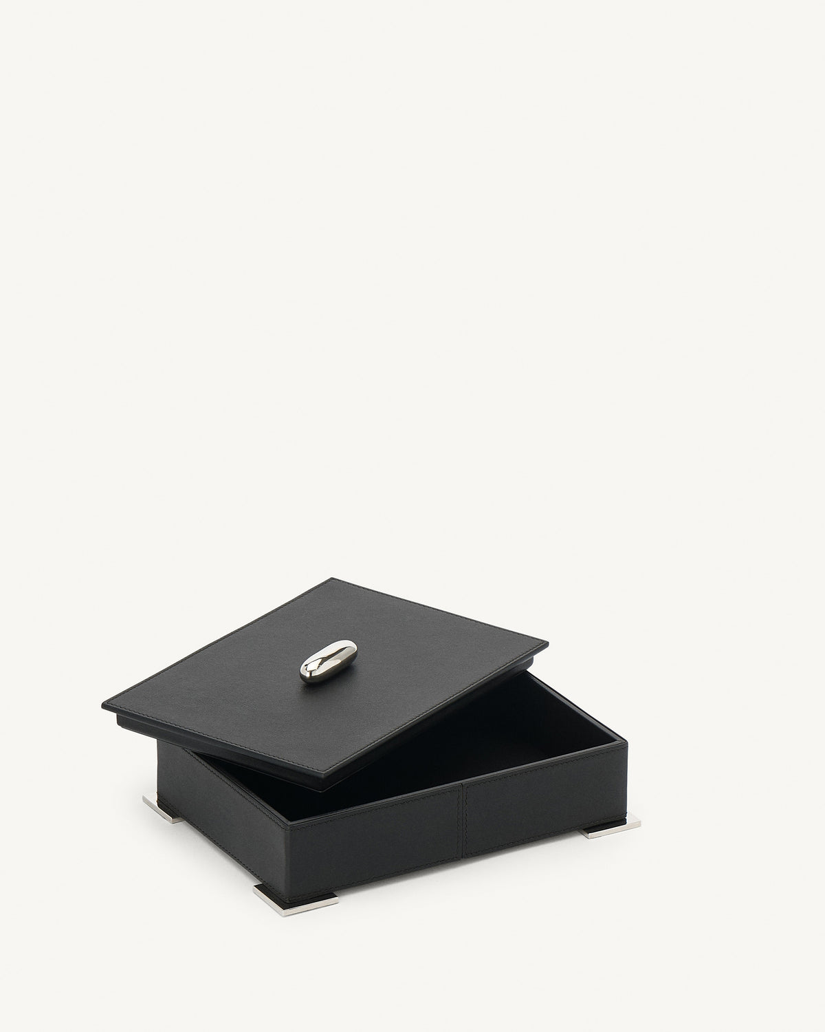 interior view of an ebony black leather box with silver metal hardware on a white background