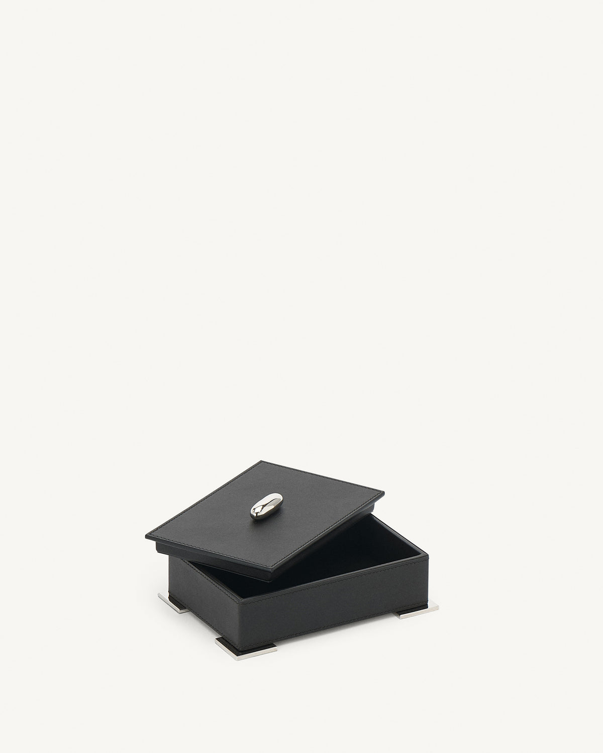 interior view of an ebony black leather box with silver metal hardware on a white background