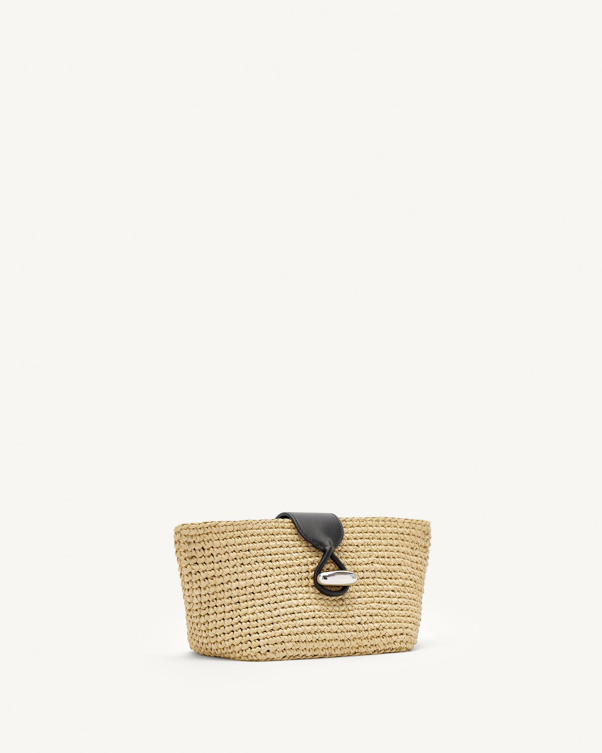 Side view of raffia pouch with black straps and silver hardware