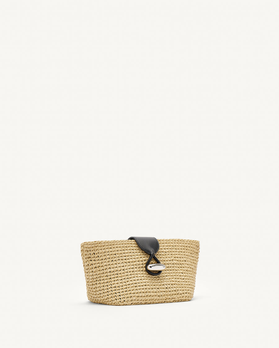 Side view of raffia pouch with black straps and silver hardware
