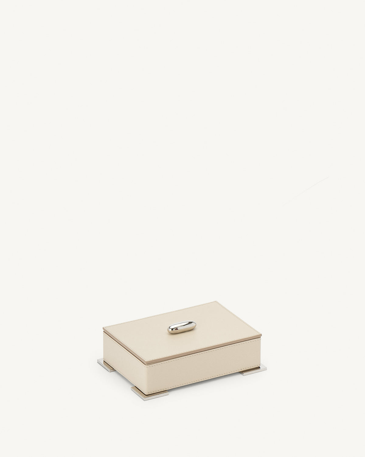 side view of a parchment beige leather box with silver metal hardware on a white background