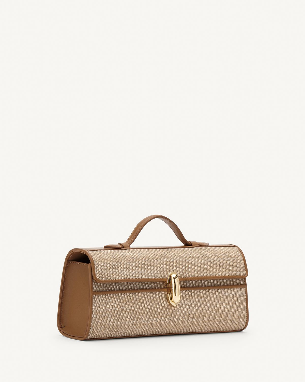 Side view of canvas handbag with a gold clasp on a white background