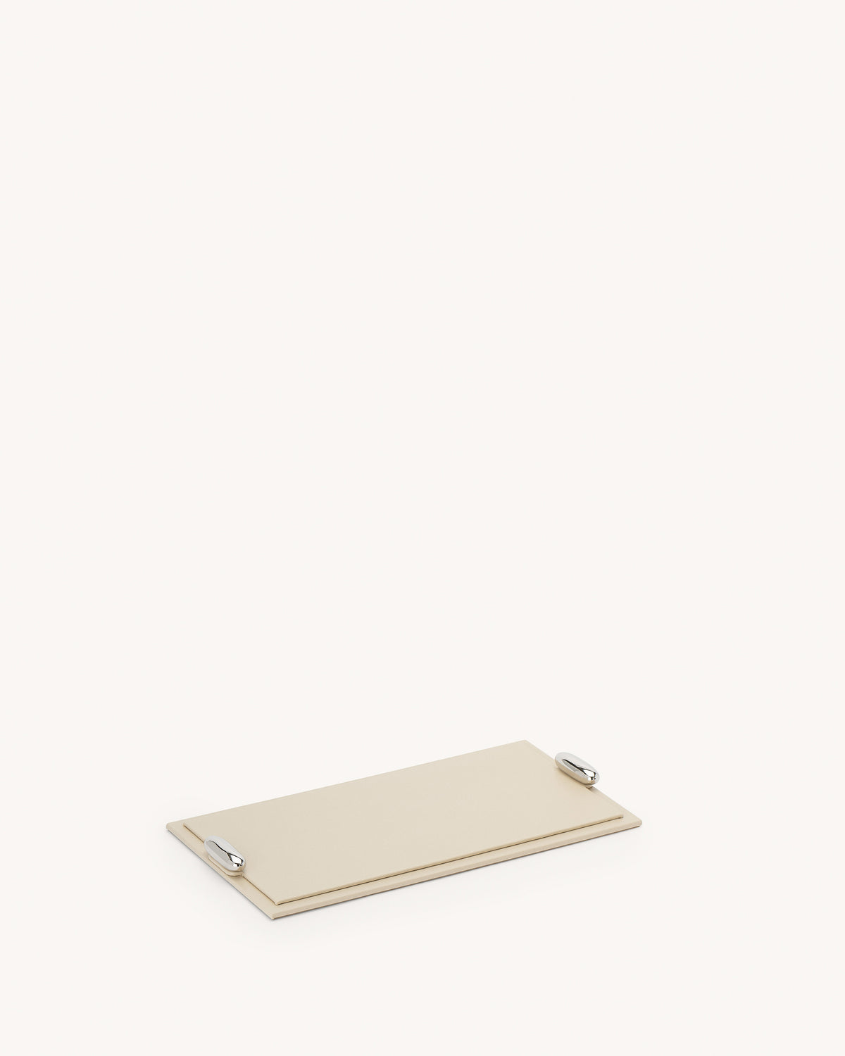 side view of a parchment beige leather tray with silver hardware on a white background