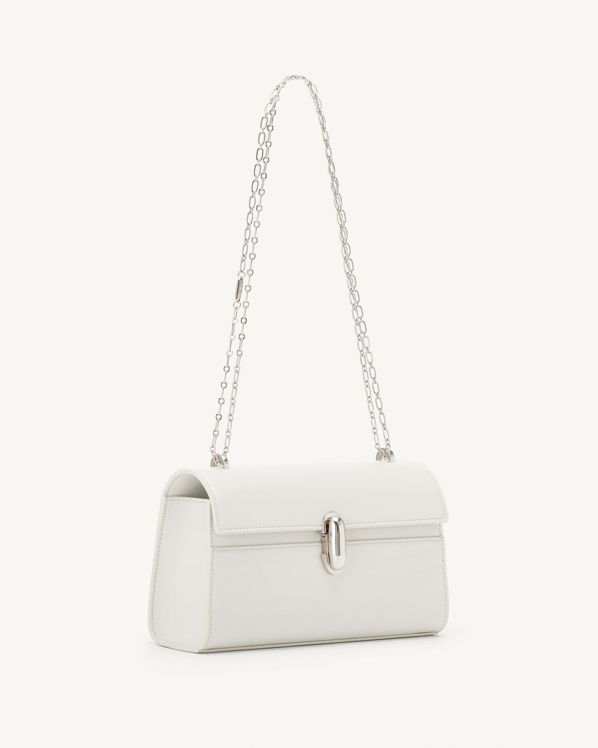 side view of an ivory leather bag with silver clasp and silver chain on a white background