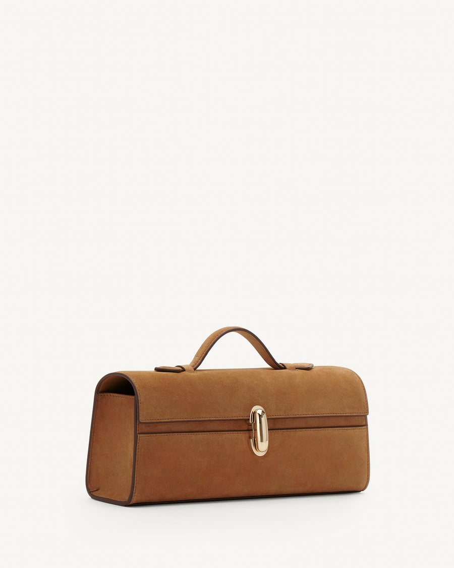 Side view of Saddle Suede leather handbag with a silver clasp on a white background