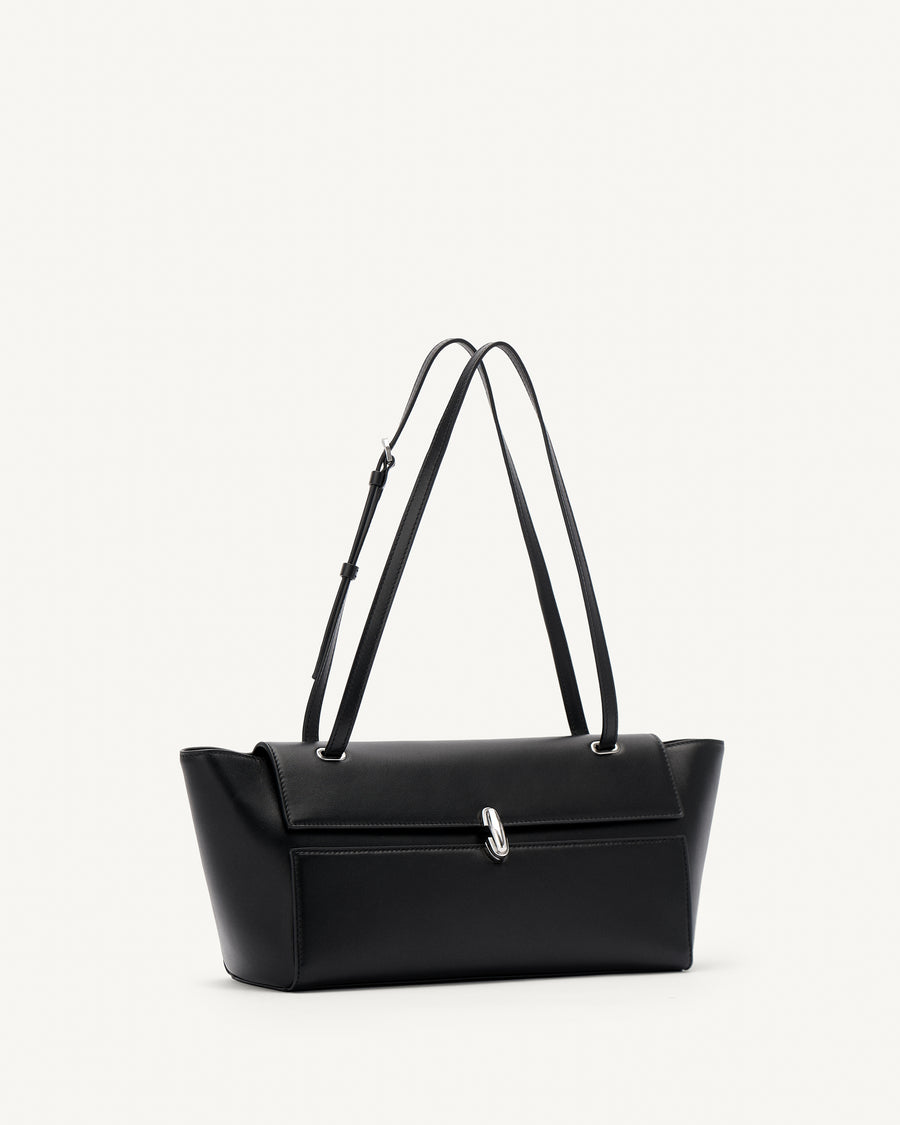 side view of black leather bag with a silver clasp on a white background