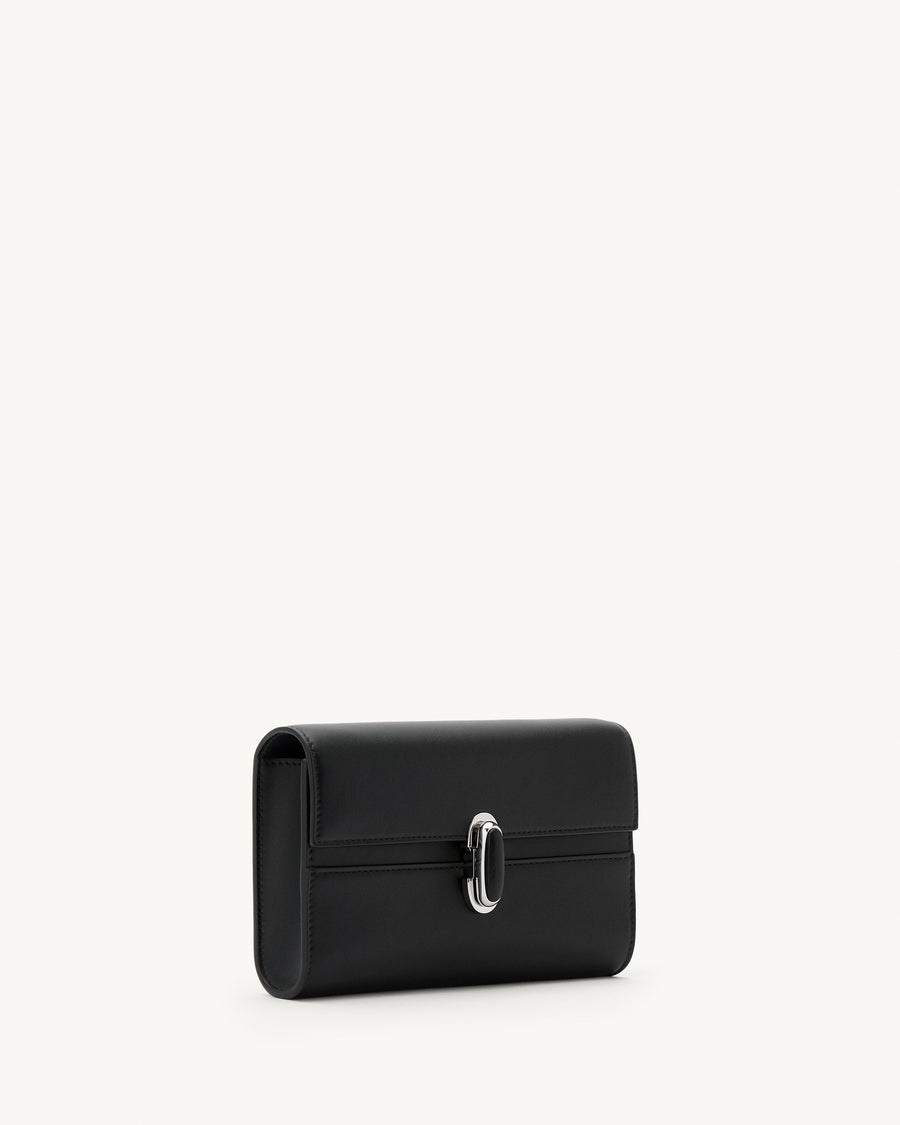 side view of a black leather handbag with a black leather covered silver clasp on a white background 