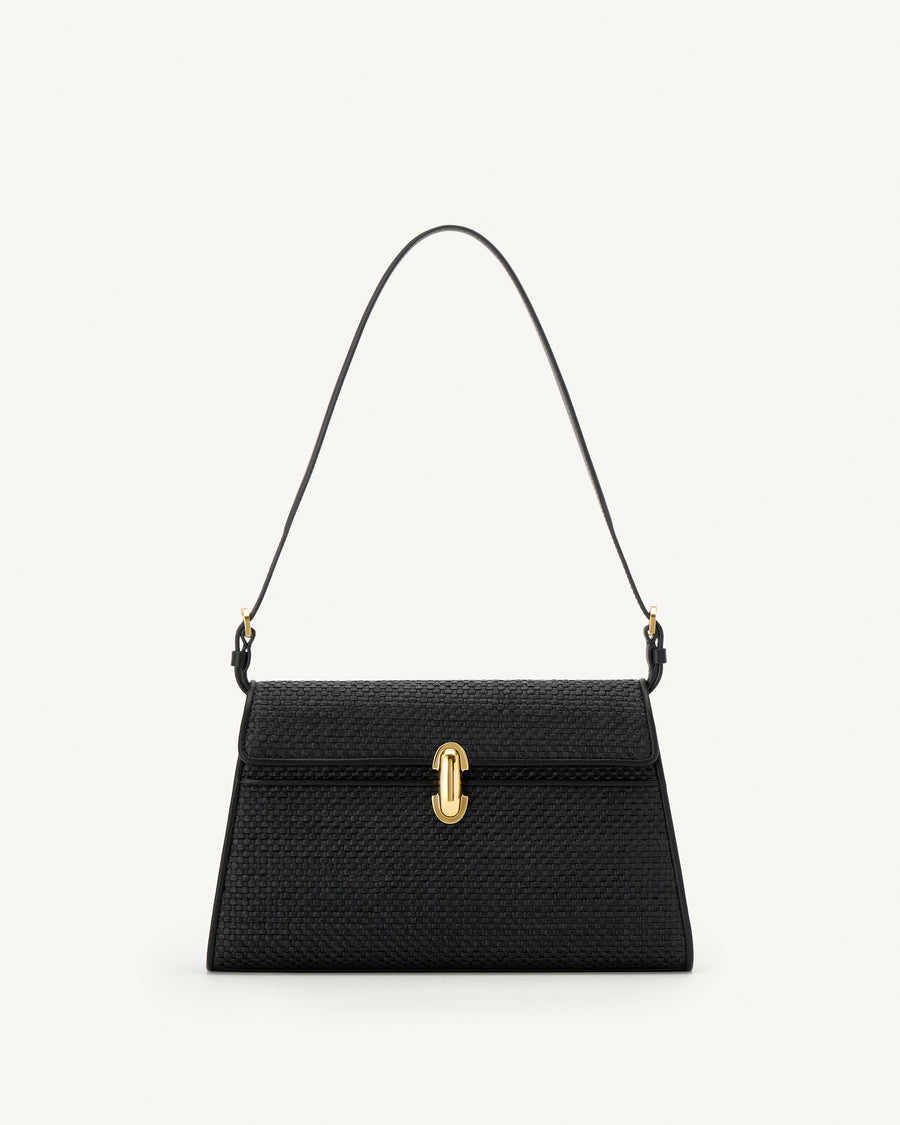 front view of a black raffia bag with leather trim with a gold clasp on a white background