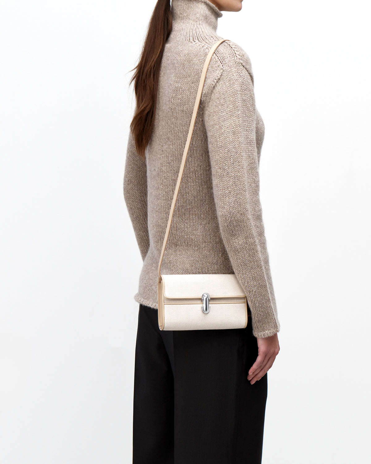On model view of white canvas crossbody with silver hardware