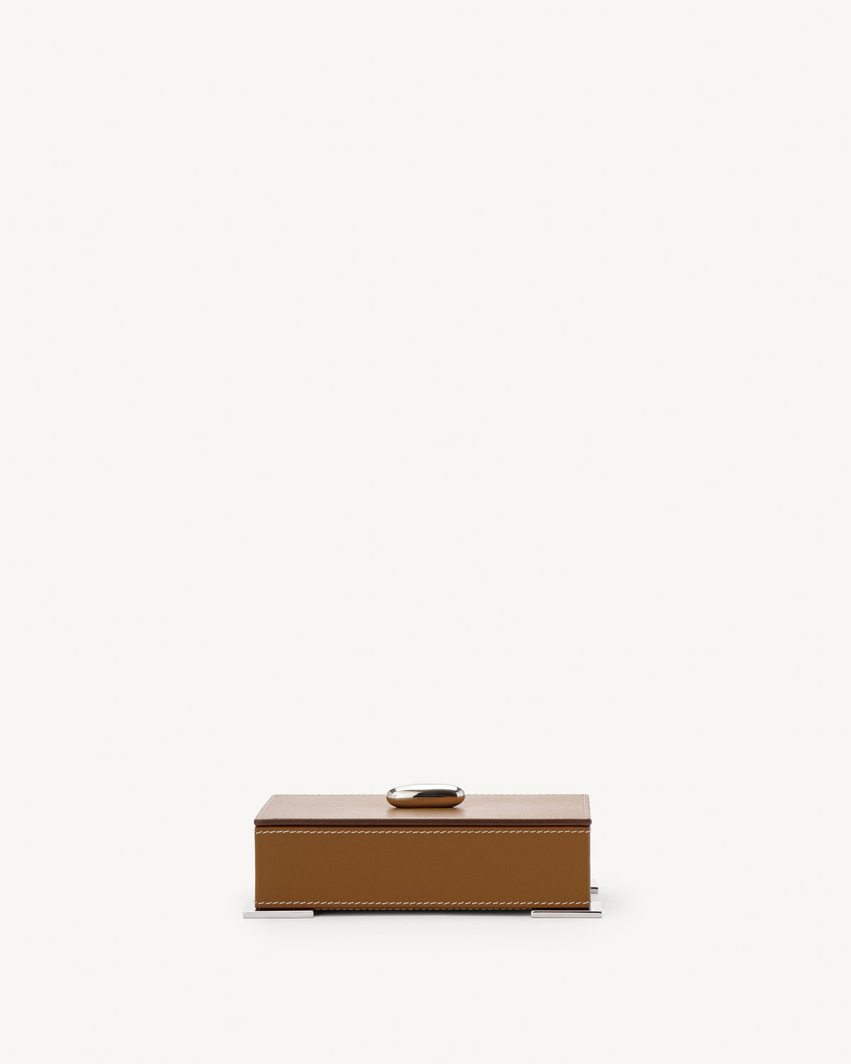 front view of a saddle brown leather box with silver hardware on a white background