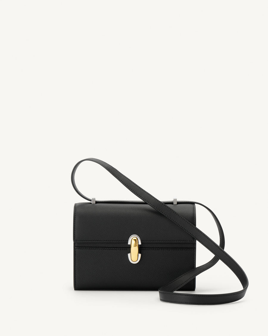 front view of a black leather bag with a silver and gold clasp on a white background