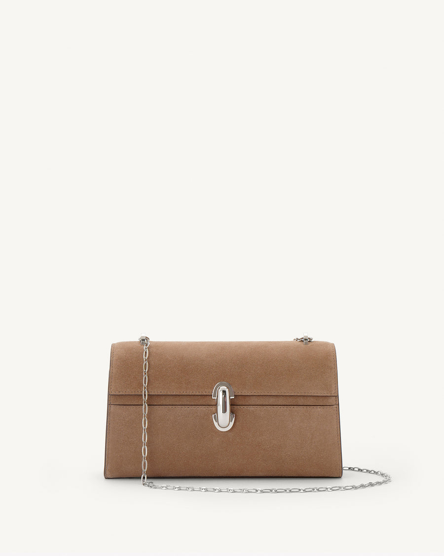 interior view of a currant brown bag with silver clasp on a white background