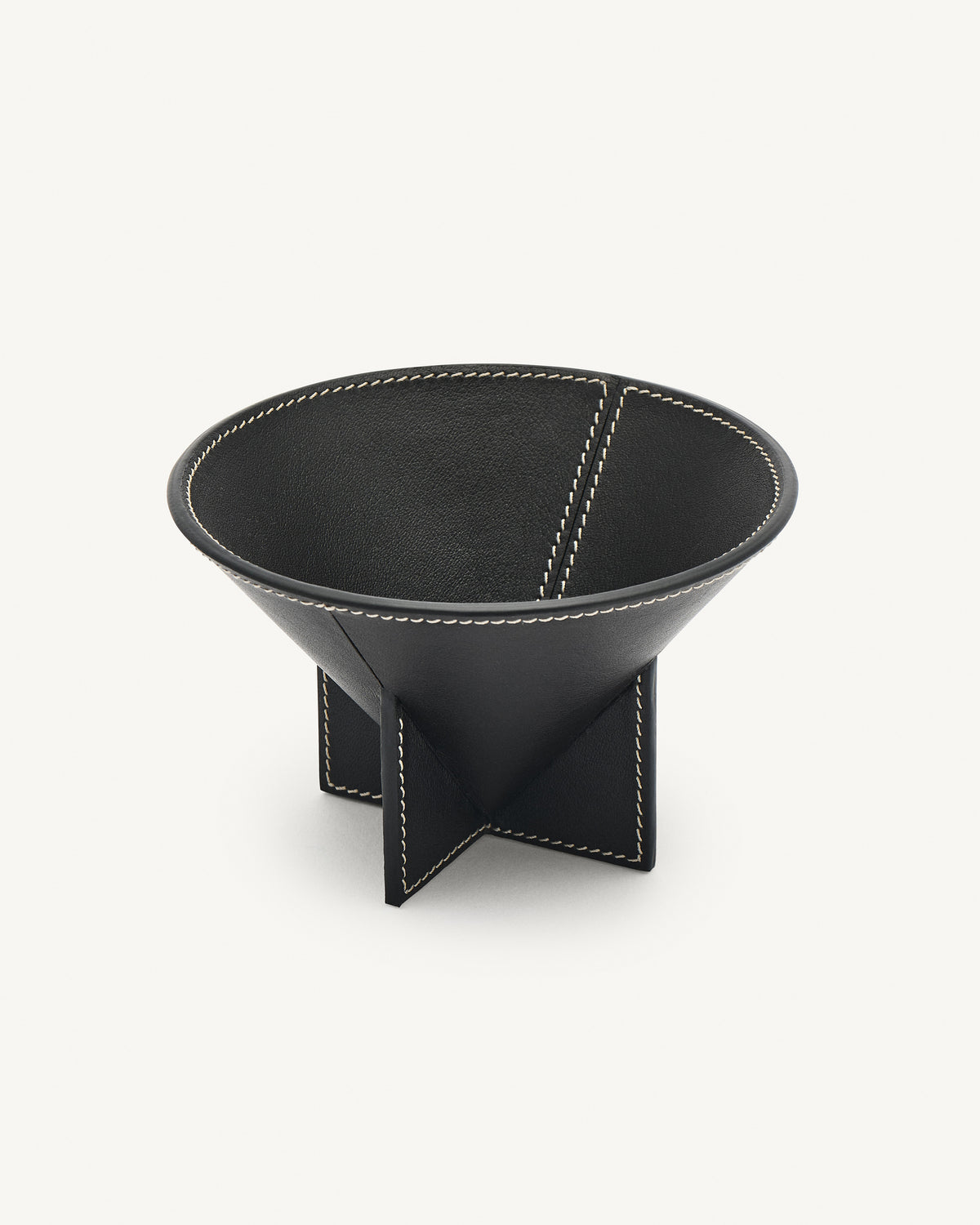 interior view of an ebony black leather dish on a white background