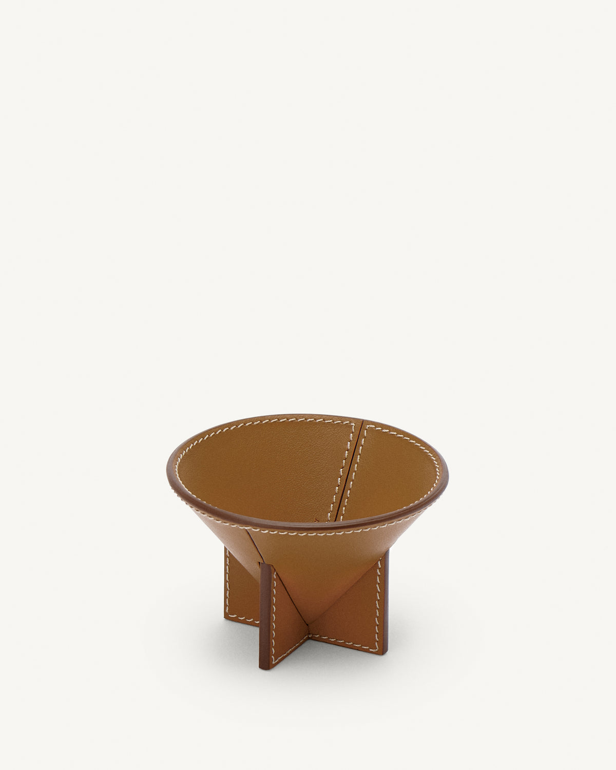 interior view of saddle brown leather dish on a white background