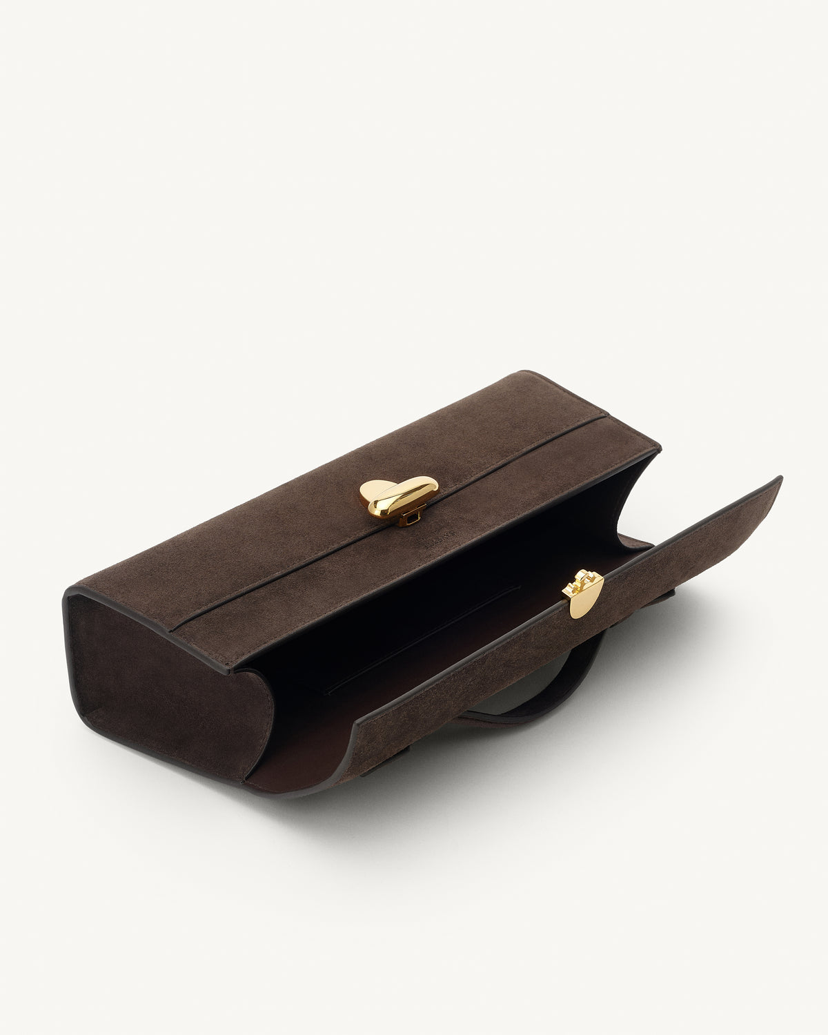 interior view of a coffee brown suede top handle bag with a gold clasp on a white background 