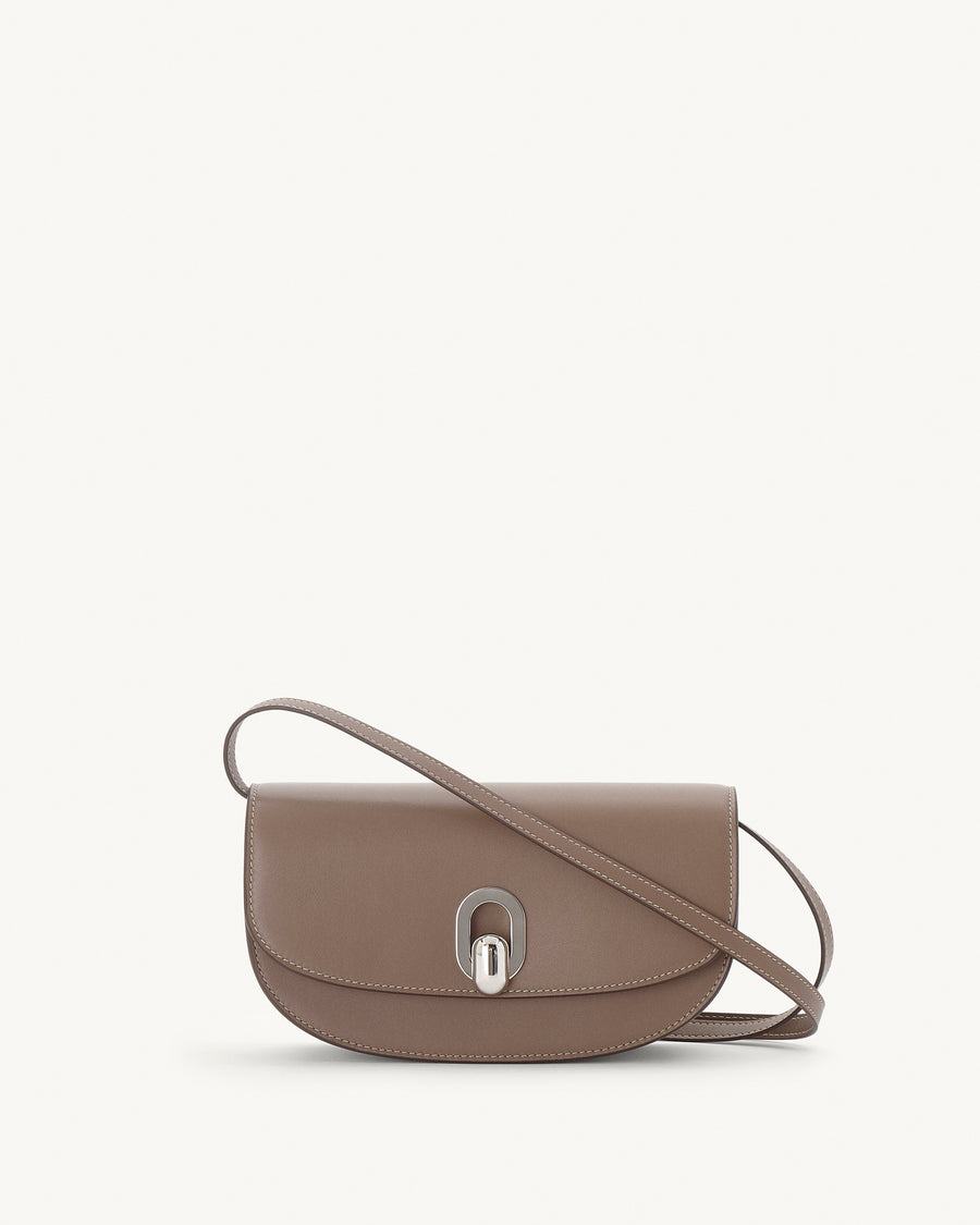 front view of a taupe brown leather bag with silver hardware on a white background