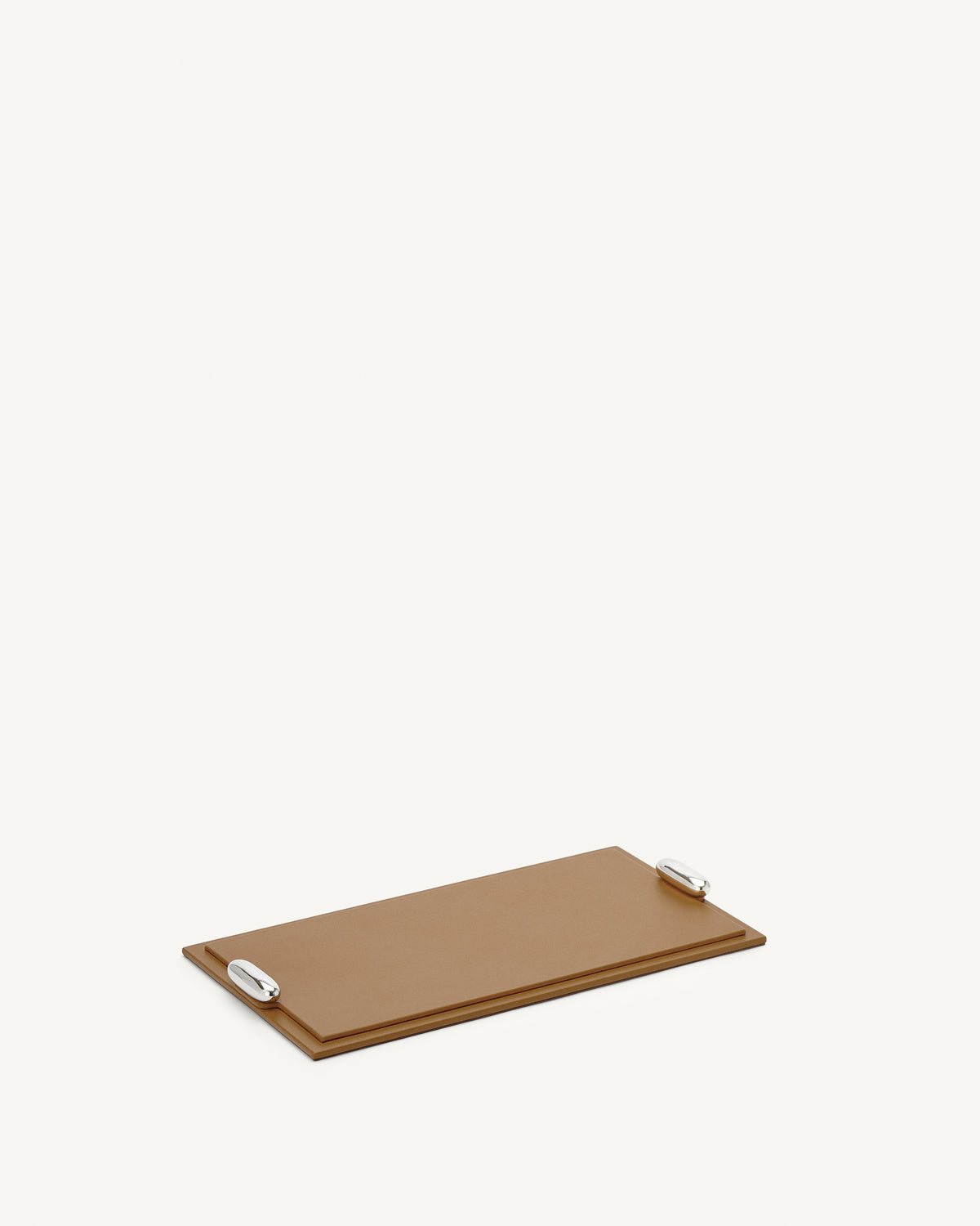 side view of a saddle brown leather tray with silver hardware on a white background