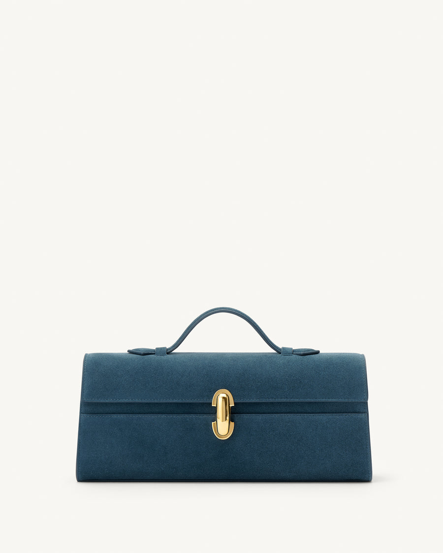 front view of a baltic blue suede top handle bag with a gold clasp on a white background 