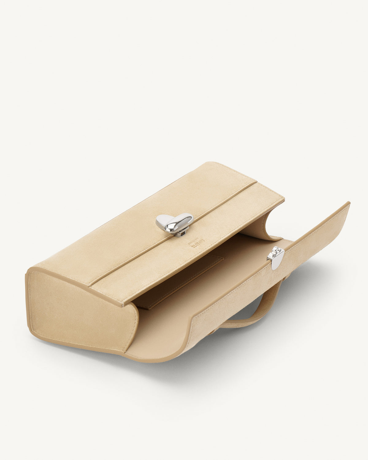 interior view of flax beige suede bag with silver clasp on a white background