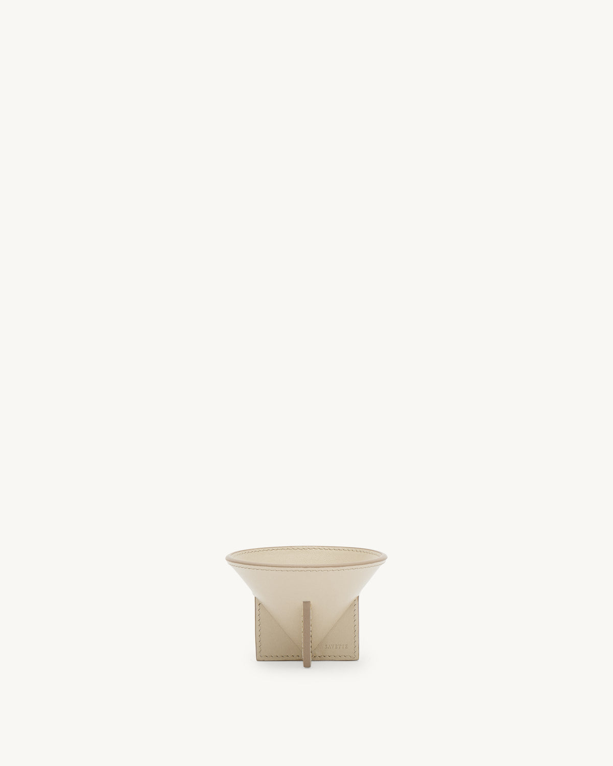 front view of a parchment beige leather dish on a white background