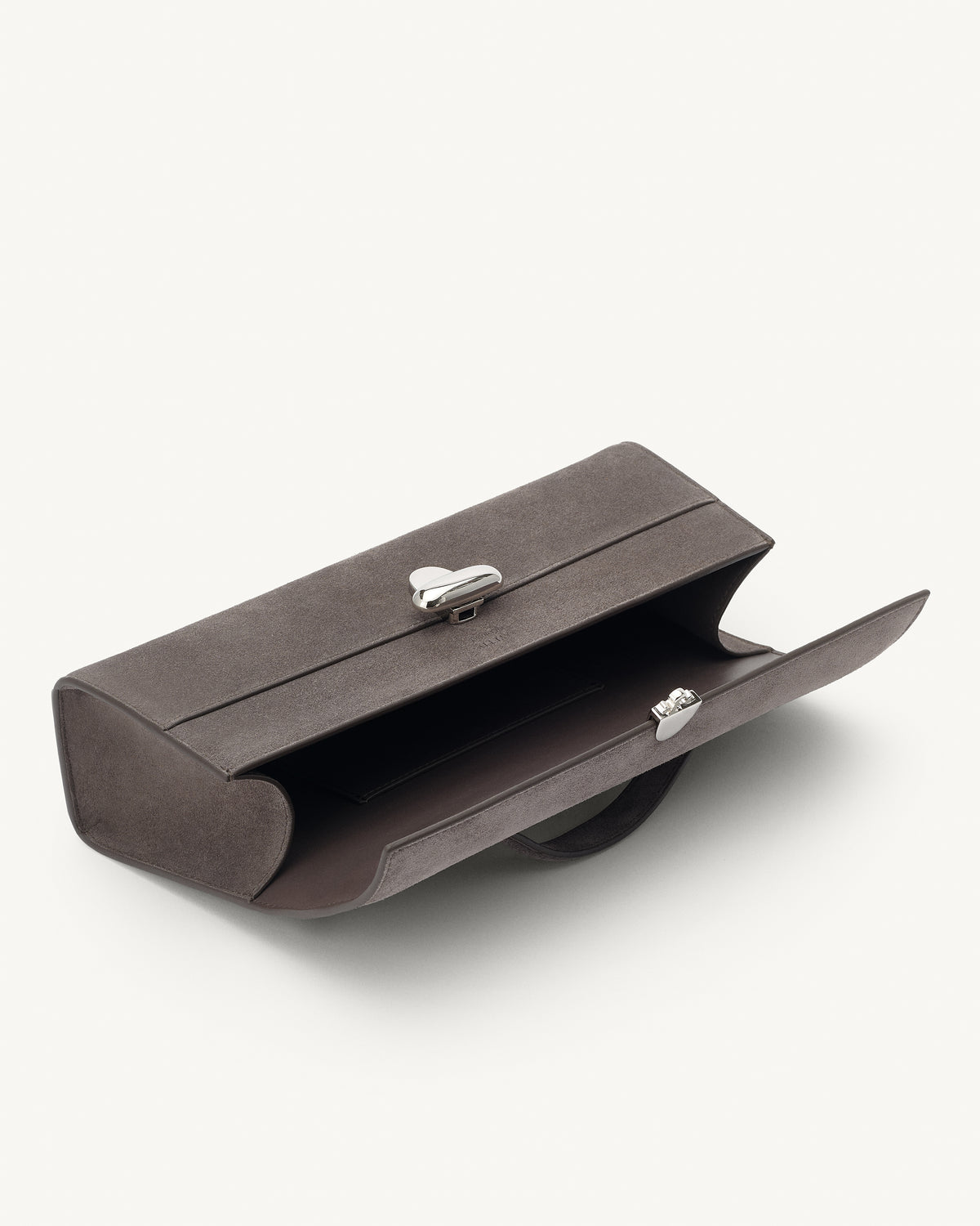 interior view of a smoke grey suede handbag with a silver clasp on a white background 