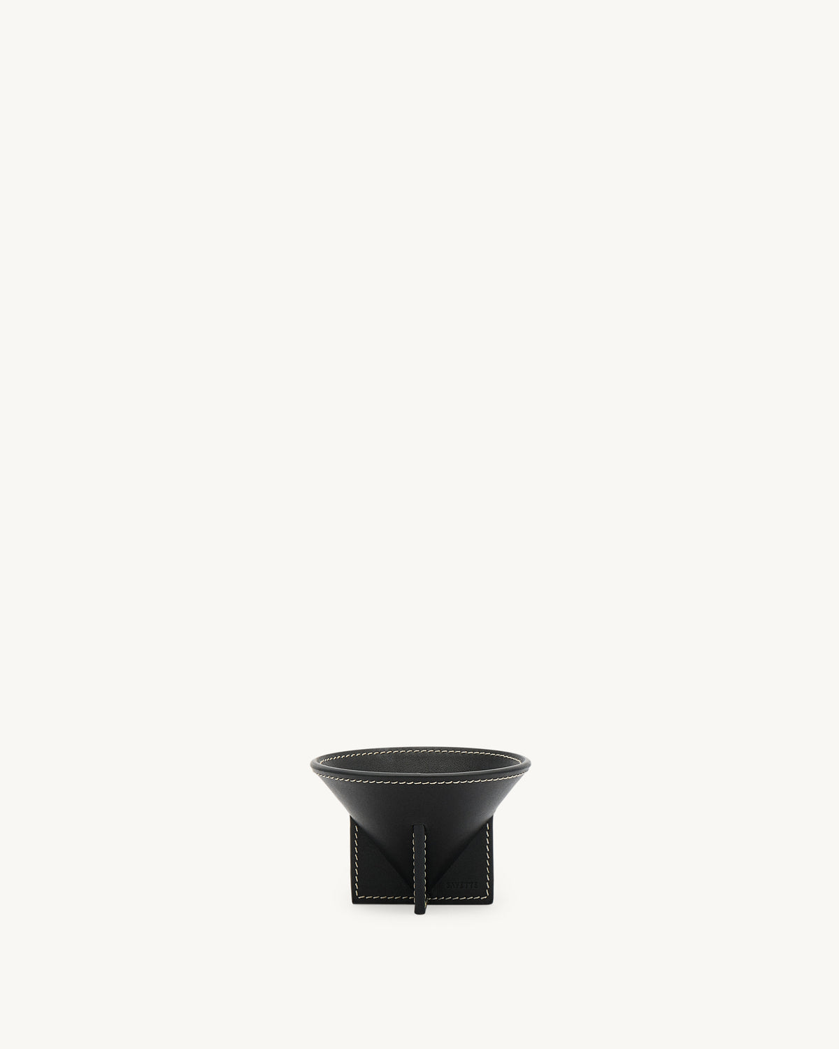 front view of a ebony black leather dish with white stitching on a white background
