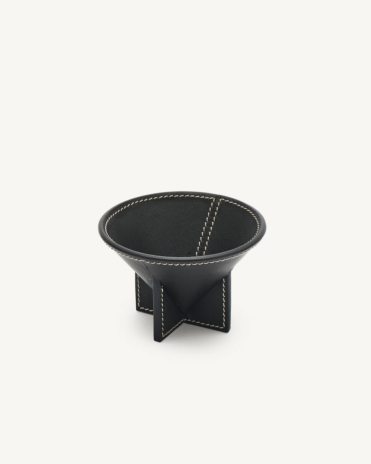 interior view of an ebony black leather dish on a white background