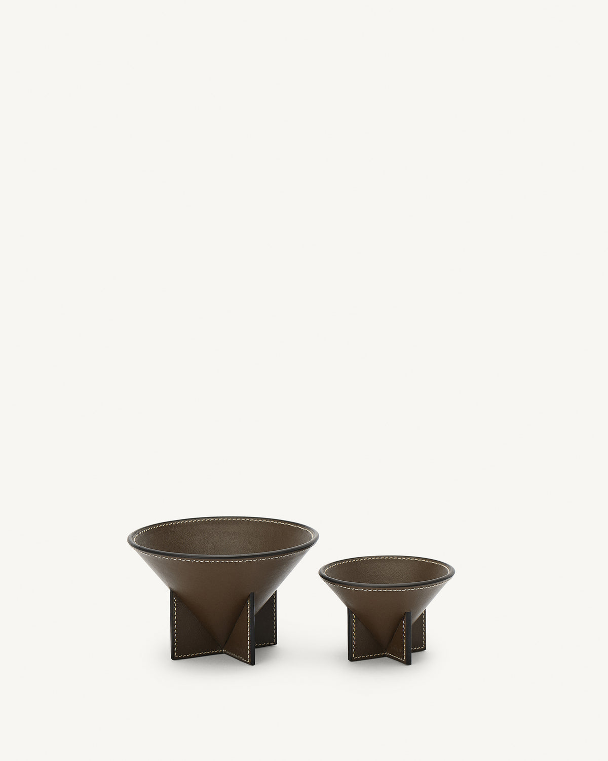 front view of two mink brown leather dishes on a white background