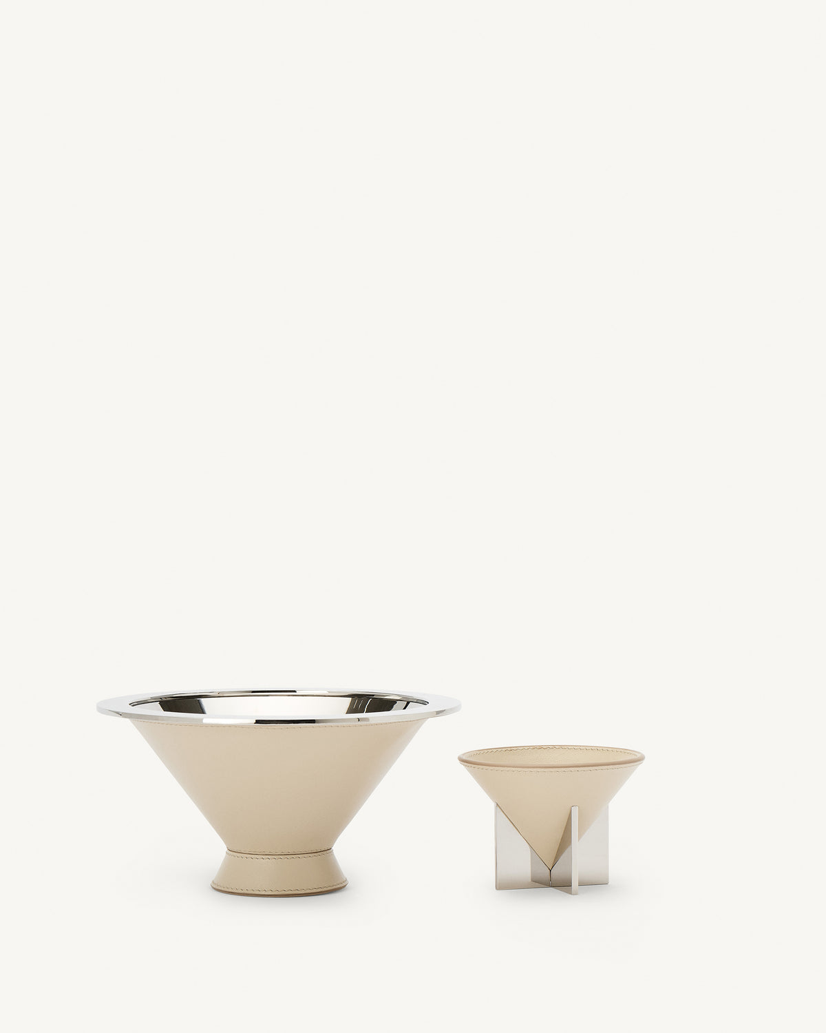 front view of two parchment beige leather dishes on a white background
