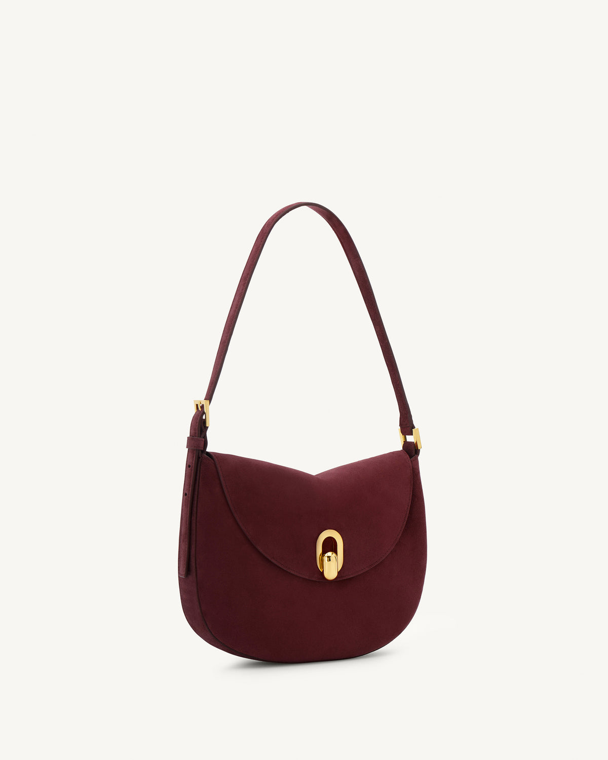 side view of a plum red suede bag with gold hardware on a white background