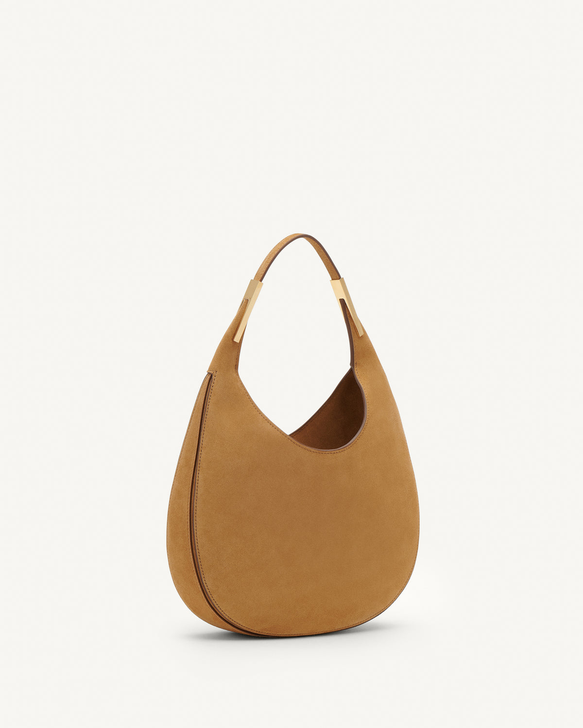 Side view of saddle suede small tote bag with gold hardware on a white background