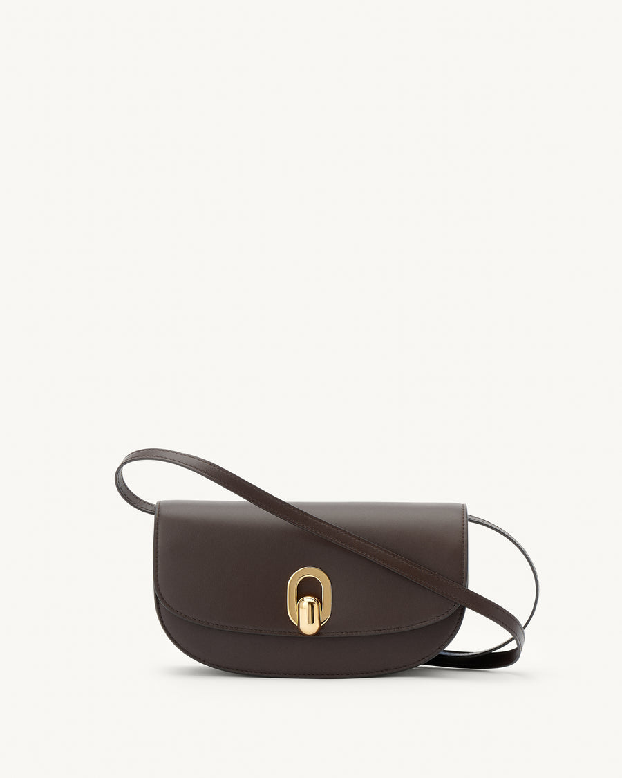 front view of a coffee brown leather handbag with gold hardware on a white background
