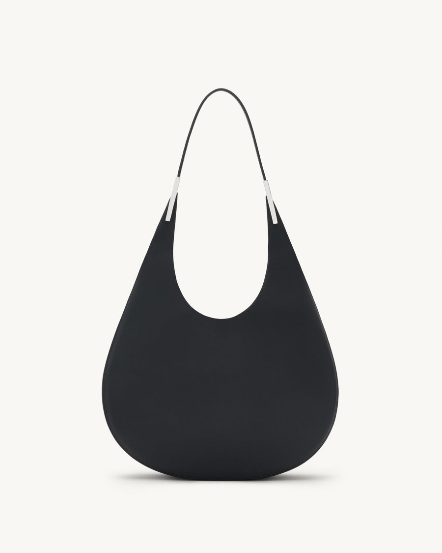 front view of black leather bag with silver hardware on a white background