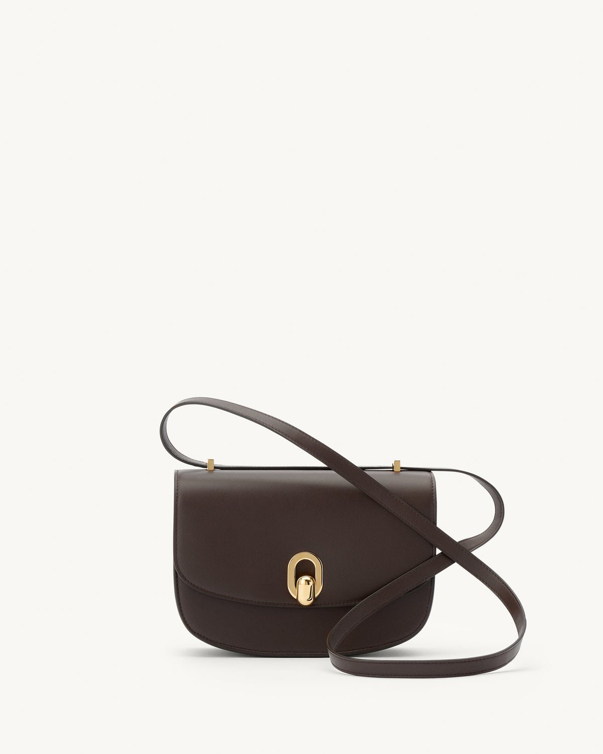 front view of a coffee brown leather bag with gold hardware on a white background