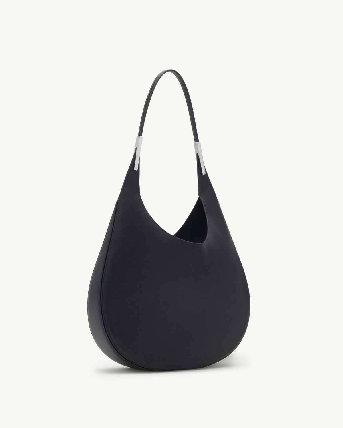 side view of black leather bag with silver hardware on a white background