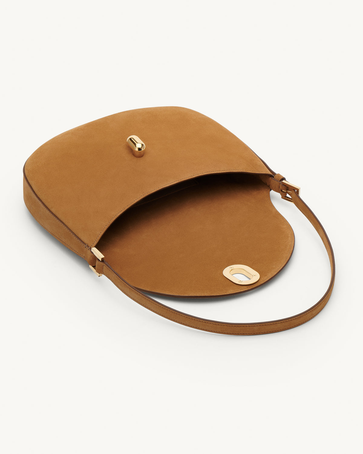 Inside view saddle suede handbag with a gold clasp on a white background