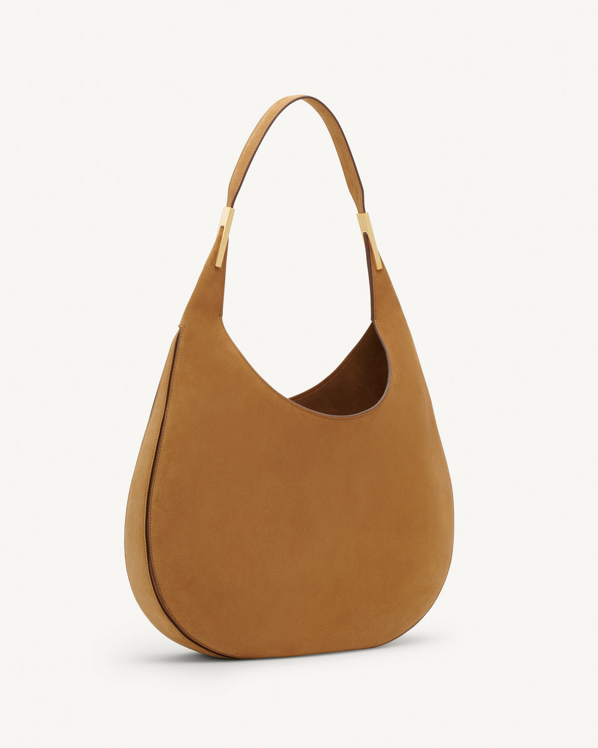 Side view of saddle suede tote bag with gold hardware on a white background