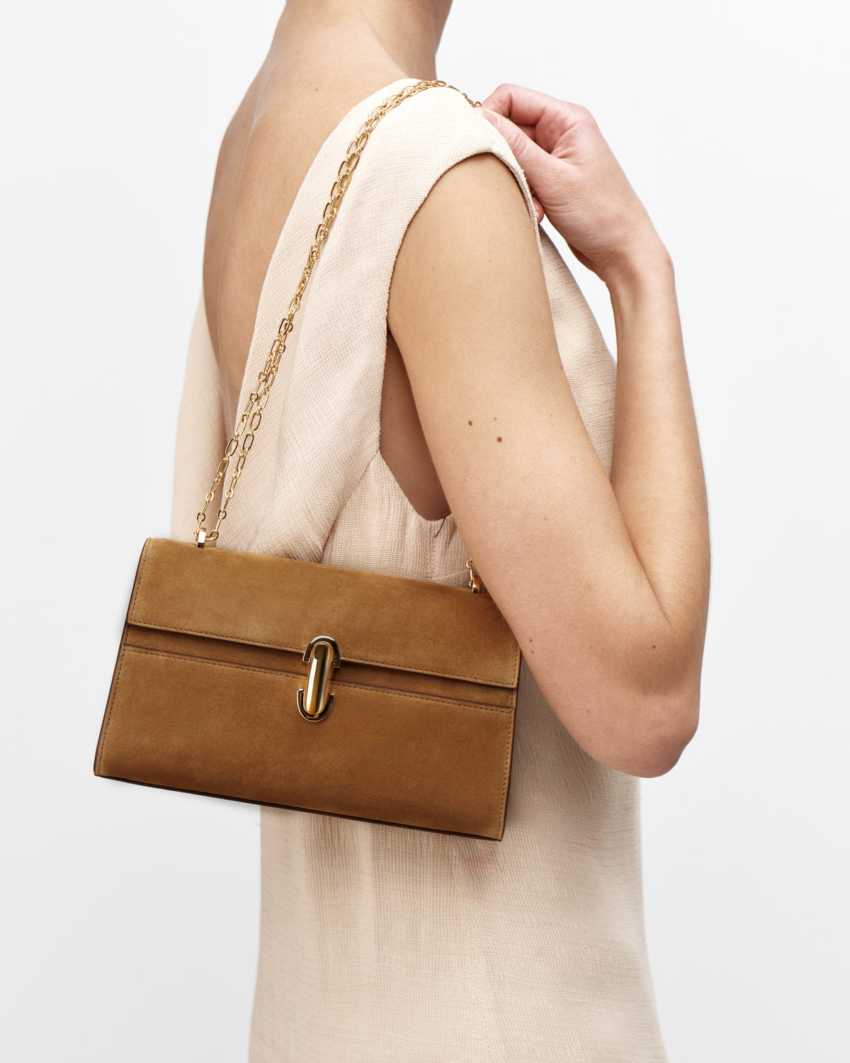 On model view of saddle suede leather crossbody with gold chain and hardware