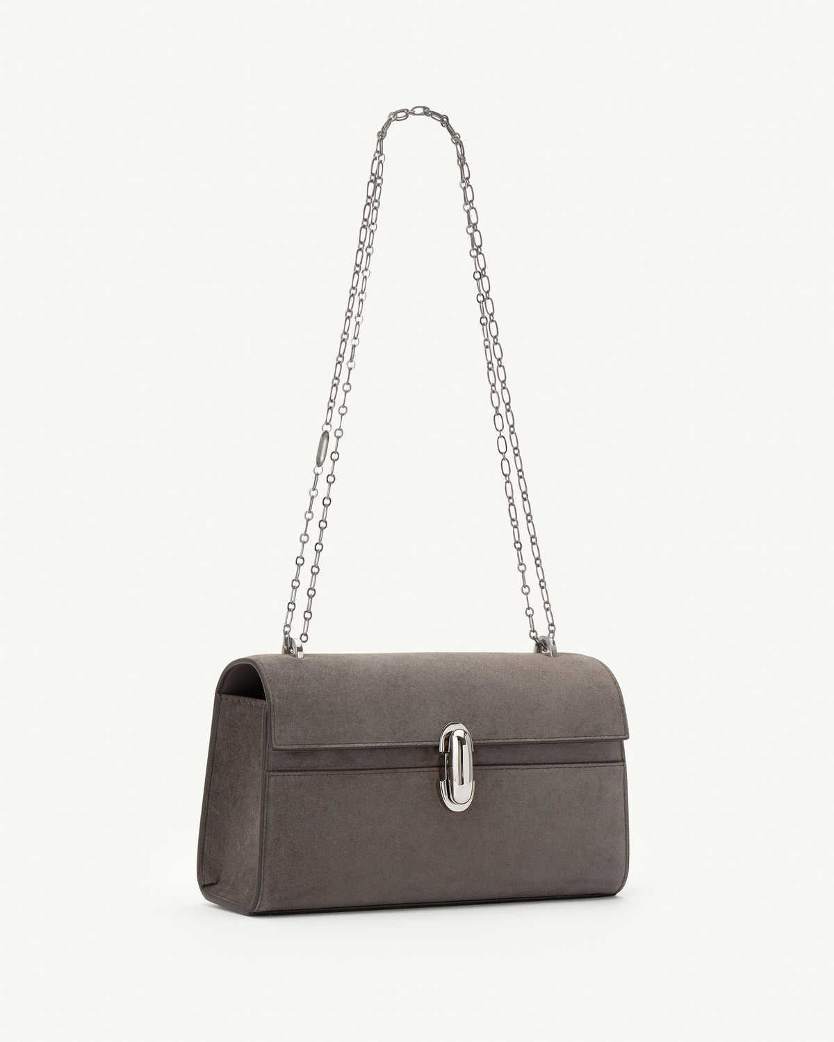 side view of a smoke grey suede bag with a silver chain and silver clasp on a white background 