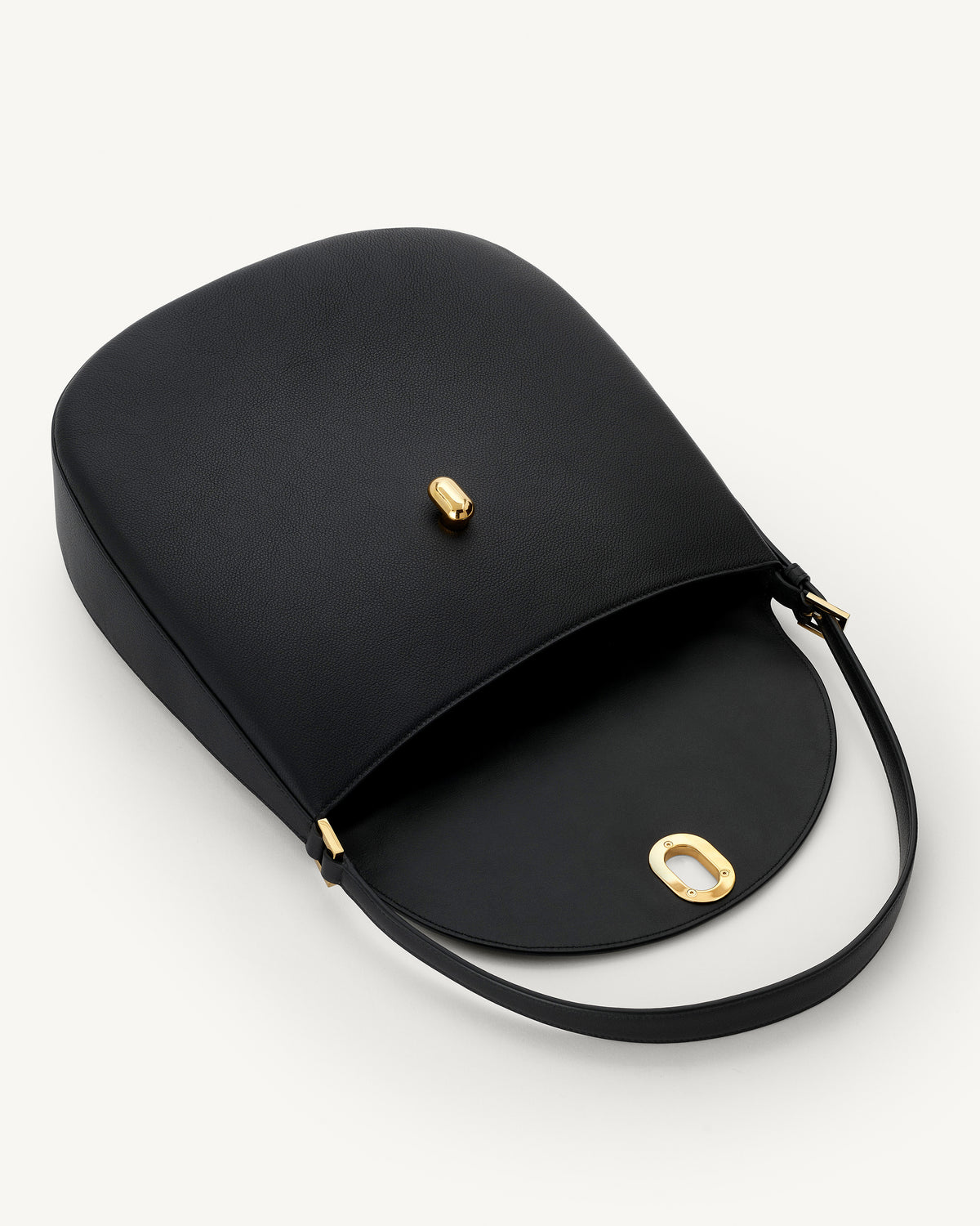 interior view of a black leather bag with gold hardware on a white background
