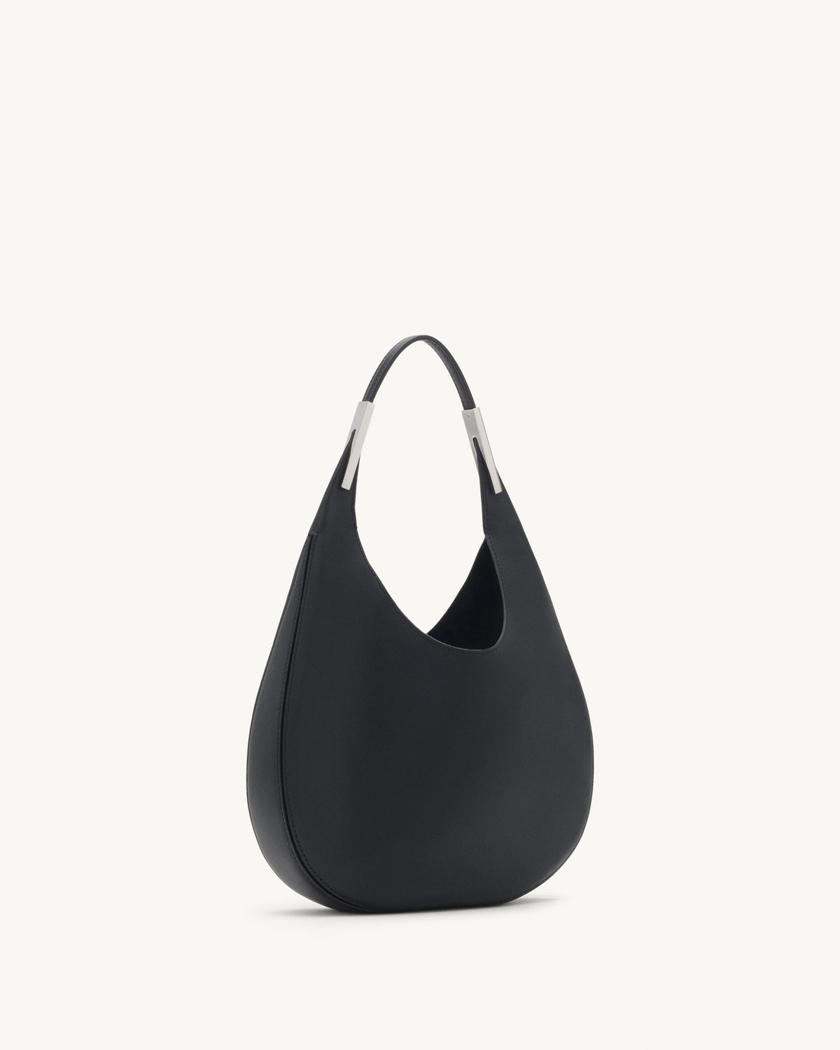 side view of black bag with silver hardware on a white background