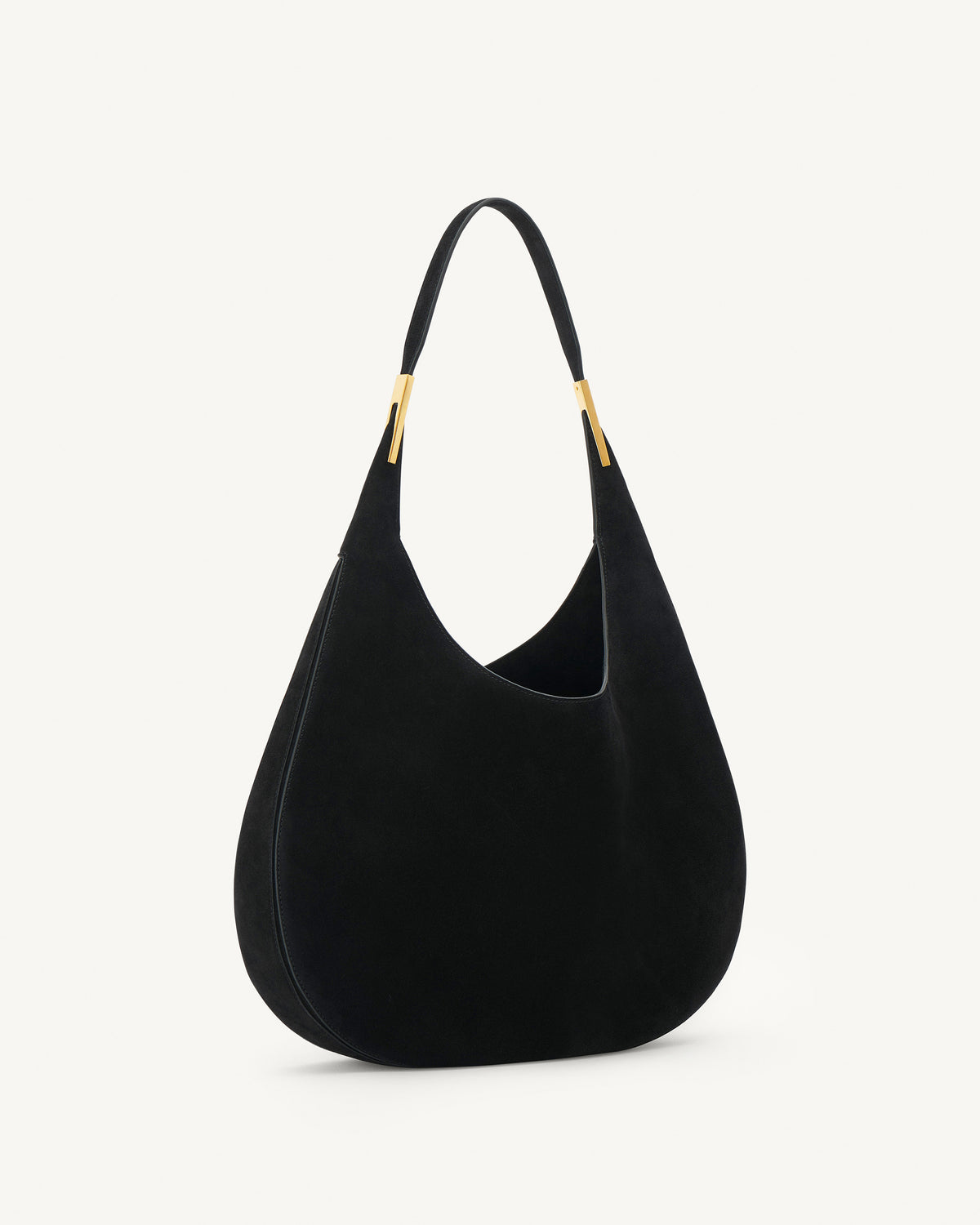 side view of black suede bag with gold hardware on a white background