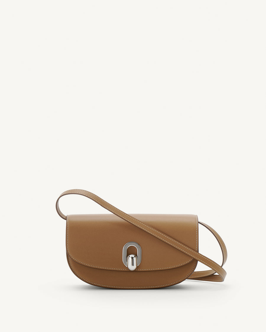 Front view of saddle leather crossbody with silver hardware
