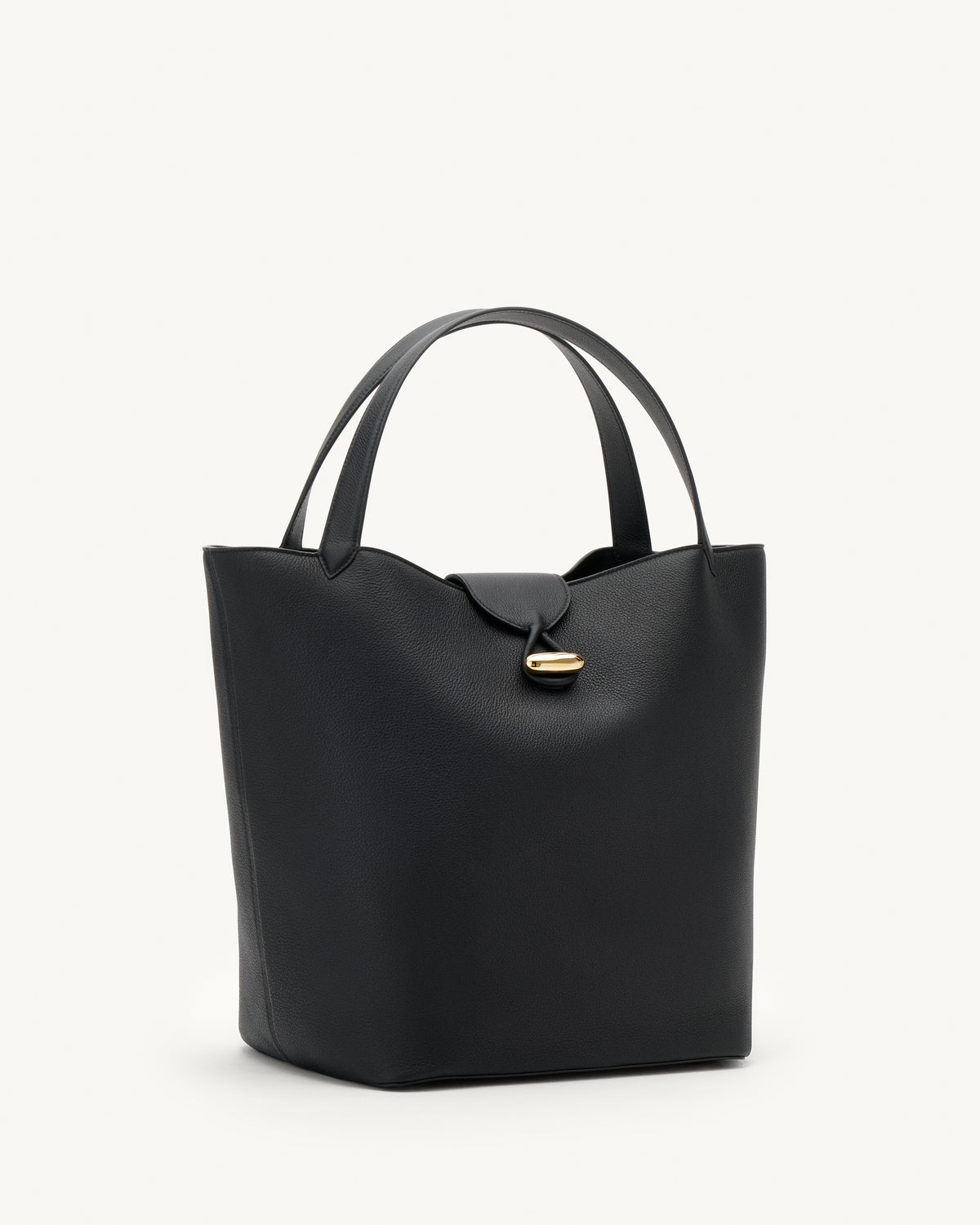 side view of a black tote bag with gold hardware on a white background