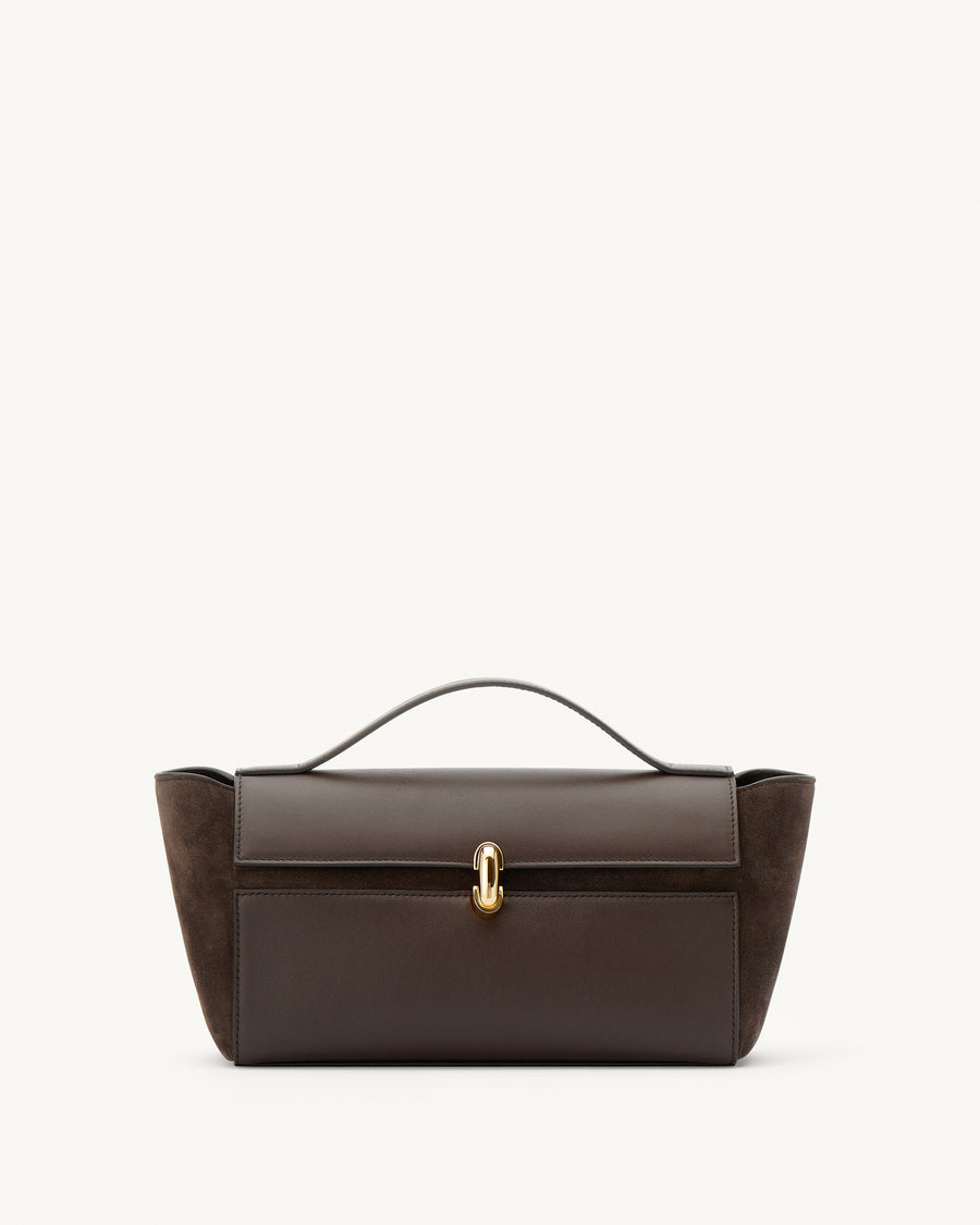 front view of a coffee brown top handle bag in smooth and suede leather with a gold clasp on a white background 