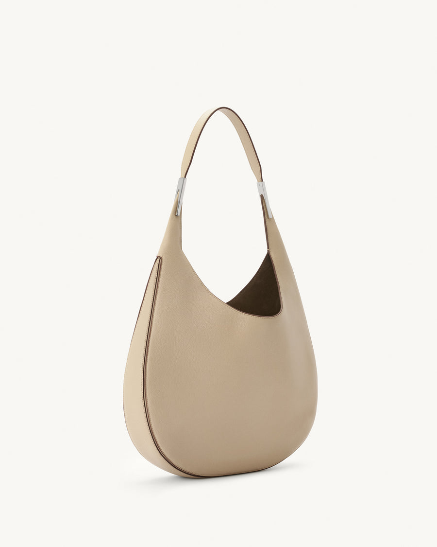 side view of bone beige bag with silver hardware on a white background
