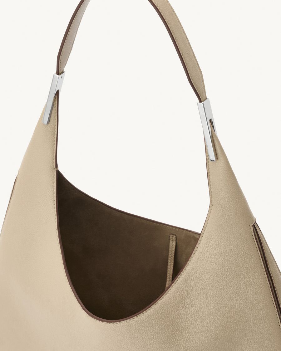 interior view of bone beige bag with silver hardware on a white background